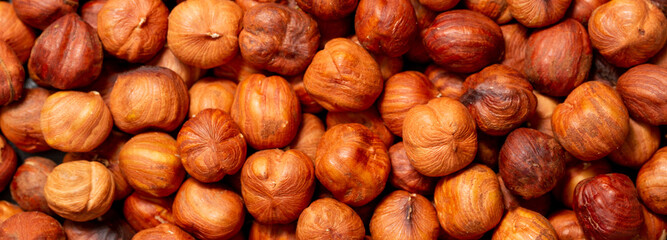 Heap of hazelnuts close-up. Peeled nuts. Hazelnut isolated on white background.
