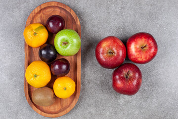 Various sweet fresh fruits on a gray background