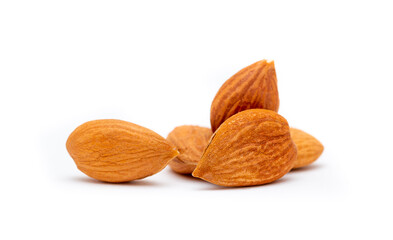 Apricot kernels peeled close-up as a background. Apricot grains heap isolated on white background.