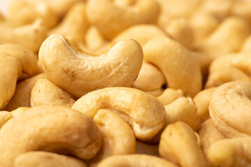 Cashew nuts as a background, top view. Cashew isolated on white background. Healthy foods.