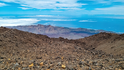 Hiking trail over volcanic desert terrain leading to summit of volcano Pico del Teide from Pico...