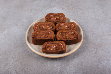 Chocolate cake roll on ceramic plate