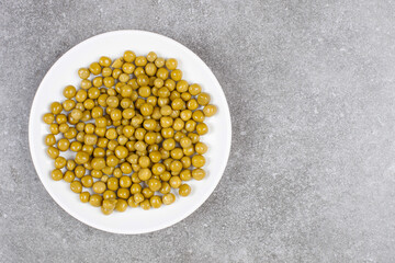 Delicious canned peas on white plate