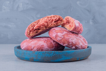 Cookies bundled up on a small blue platter on marble background