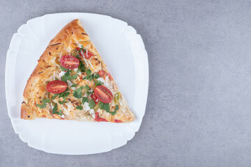 A slice of pizza on a platter on marble background