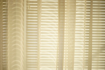 Sunny organza tulle with sunlight and blinds shadows.