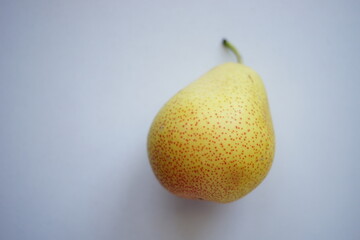 Yellow orange pear on a white table