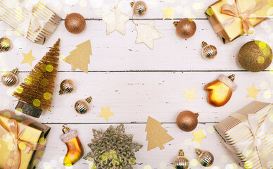 Obraz na płótnie Canvas Christmas decorative composition with gold shiny snowflakes, christmas golden balls, gift boxes on rustic white wood background. Christmas or New Year concept. Festive Christmas background.