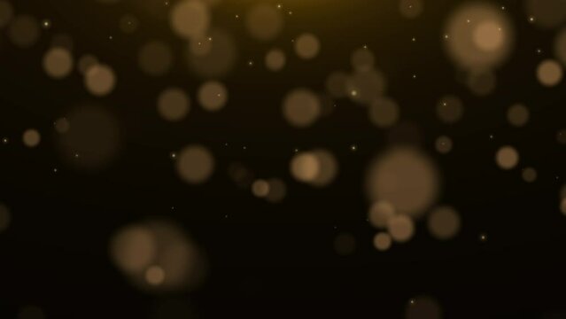 Golden glowing dust particles. Christmas light, bokeh. Blurred motion. Glowing dust, golden light.