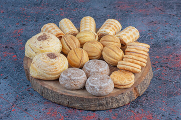 A delectable pastry assortment on a wooden board on abstract background