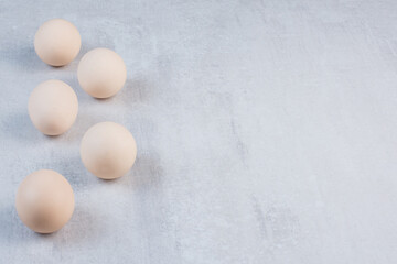 Eggs neatly arranged on marble background