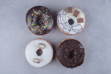 Bundle donuts with various toppings on marble background