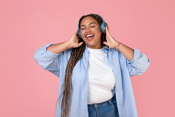 Fototapeta premium Black Lady Listening Music Online Wearing Headphones On Pink Background