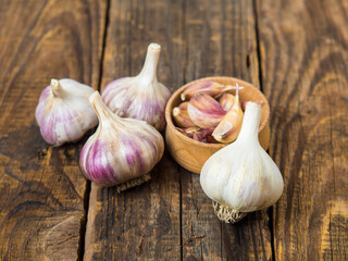 garlic. garlic clove, flask of garlic in a wooden bowl on a wooden background.Healthy food concept.