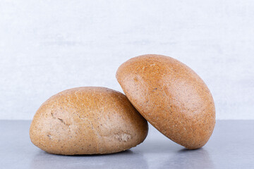 Small hamburger buns on marble background