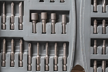 Open set of the interchangeable flat and hexagonal bits different sizes for screwdriver in gray...