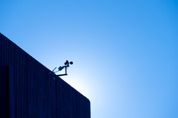 Anemometer on the top of a roof.