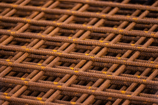 Piles of rusty rebar ready to be used at a construction site.
