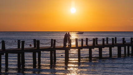 Sunset in Cozumel with a pier and the ocean