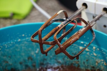 Close-up shot of a hand mixer in a brownie batter