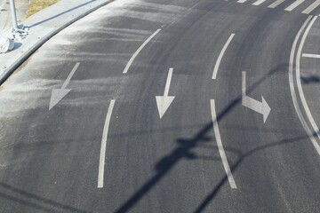 High top angle view of forward and left sign white arrow symbol on urban direction road marking...