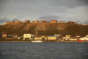 View of the community of Pond Inlet and the Pond Inlet sign in the north Baffin Region of Nunavut,...