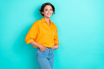 Photo of confident adorable woman bob hairstyle wear yellow blouse denim jeans arms in pockets...