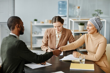 Diverse group of people in meeting or job interview at office setting, focus on Middle Eastern...