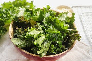 fresh torn leaves of kale cabbage close-up before cooking on a light background selective focus