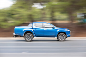 Panning shot of a car driving on a highway. Blurred photo