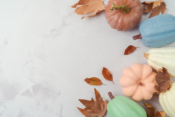 Thanksgiving holiday decoration concept. Pumpkin and autumn leaves on stone background. Top view, flat lay