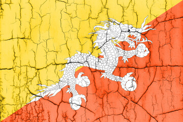 Textured photo of the flag of Bhutan with cracks.