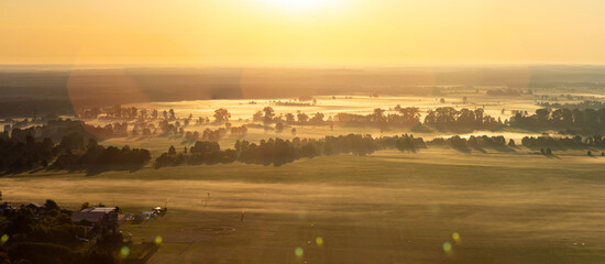 Aerial shot of misty sunrise full of sun 