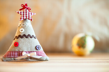 Small cloth christmas tree and xmas ball in the background. Christmas decoration. - 534059999