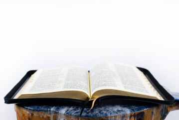 Obraz premium Open bible on the table. Holy Scripture on a white background.