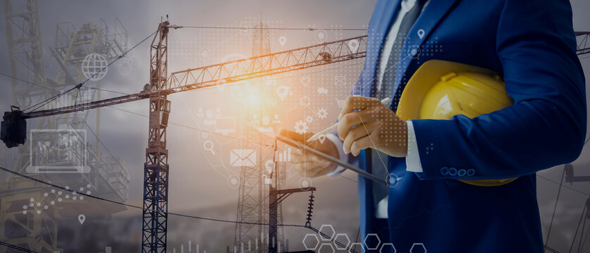 Future building construction engineering and technology project concept. double exposure graphic with engineer using digital tablet and smart industry and IOT software to control operation.