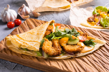 Pancake or crepe with fried shrimp tomatoes and vegetables and cheese