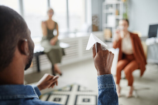 Close Up Of Black Young Man Shooting Paper Plane In Office, Employment And Ideas Concept, Copy Space