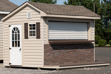 a nice new gray storage shed roof door window