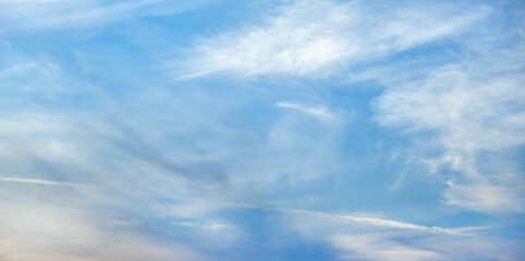 Blue sky with white clouds. Beautiful cloudy sky. Skyward. Endless skyline. The sky at dawn. Banner.