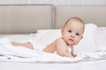 newborn baby girl in the white bed