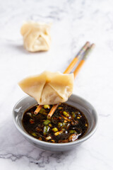 Dumpling with soy, white background