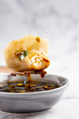 Dumpling with soy, white background