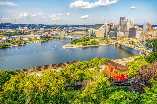 Red tram going down an incline in a city