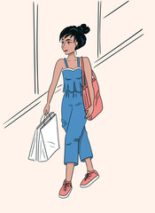 A woman with bags walks through the store.