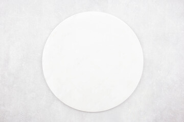 Marble round cutting board flat lay mockup on gray concrete stone background. Top view. Copy space.