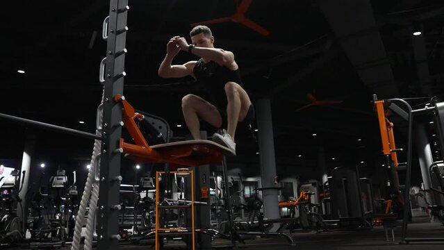 strong athlete man training jump in fitness gym. fitness and sport. athletic man jump up.