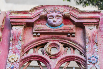 Carved decoration on a weathered antique door.