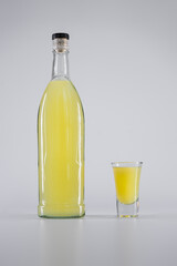 yellow colored alcohol citrus tincture or liquor with syrup, vodka, lemon