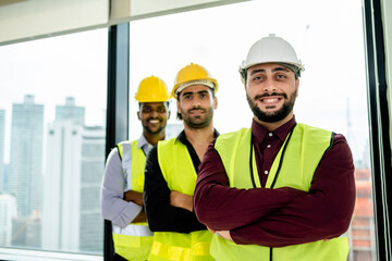 Fototapeta na wymiar A team of happy engineers cross arms together looking confident to proud victory successful architectural project, developer real estate, unity, teamwork, architecture, construction concept